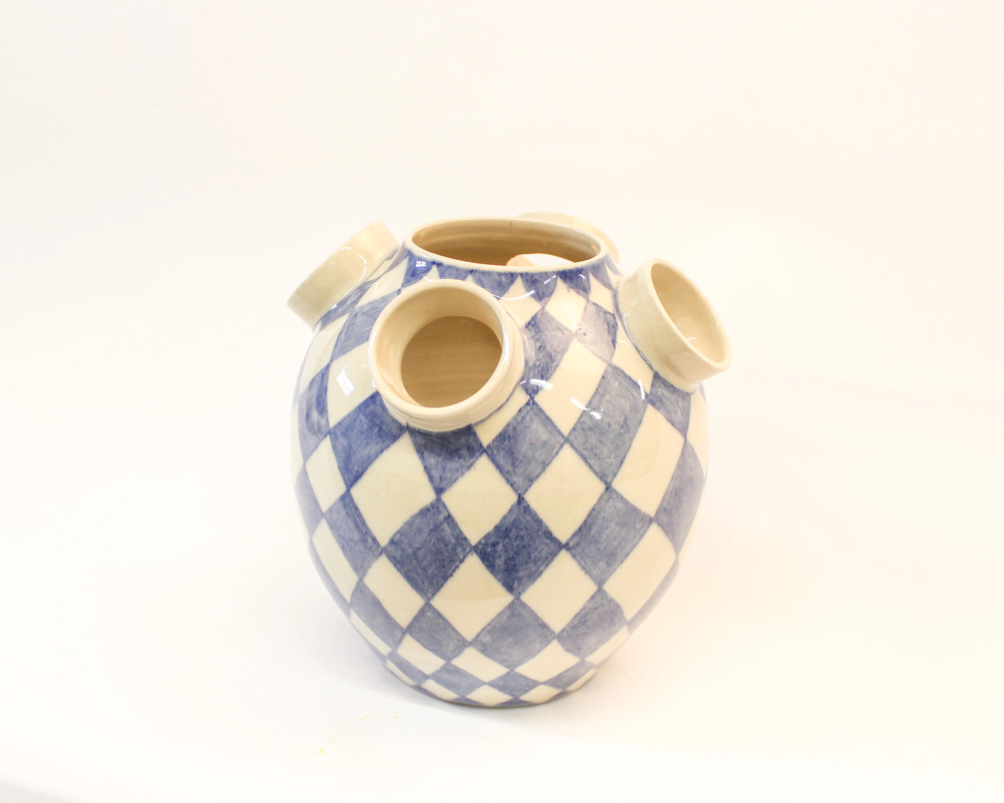 Ceramic vase with blue and white checkered pattern on a white background