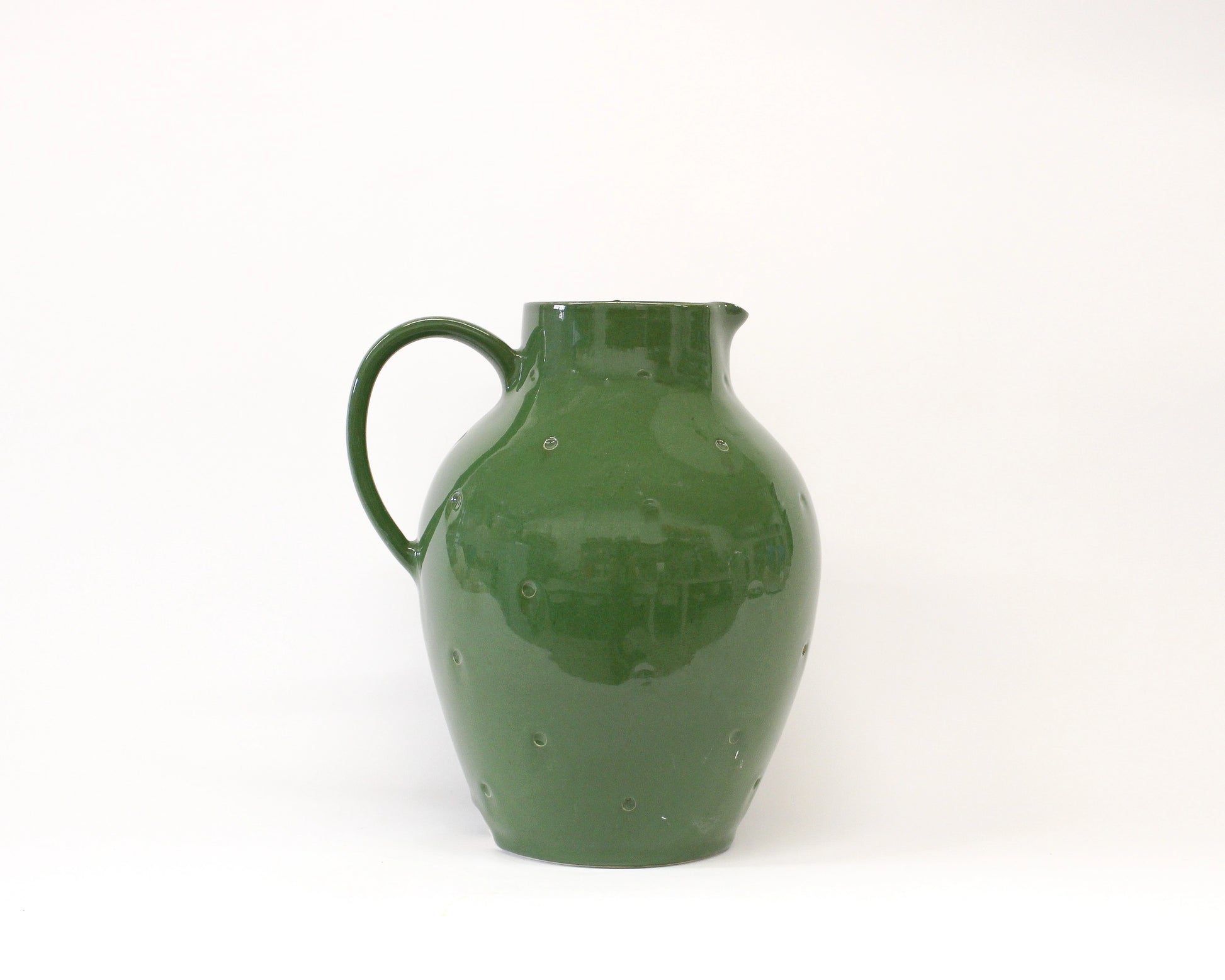 Handmade Ceramic Green pitcher on a white background from Mima Ceramics by Michelle Organ. 