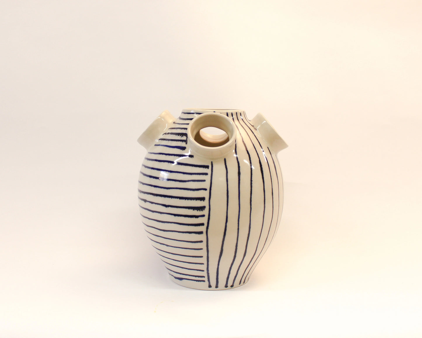 Handmade Wheel Thrown Ceramic vase with blue stripes on a white background from Mima Ceramics by Michelle Organ.  