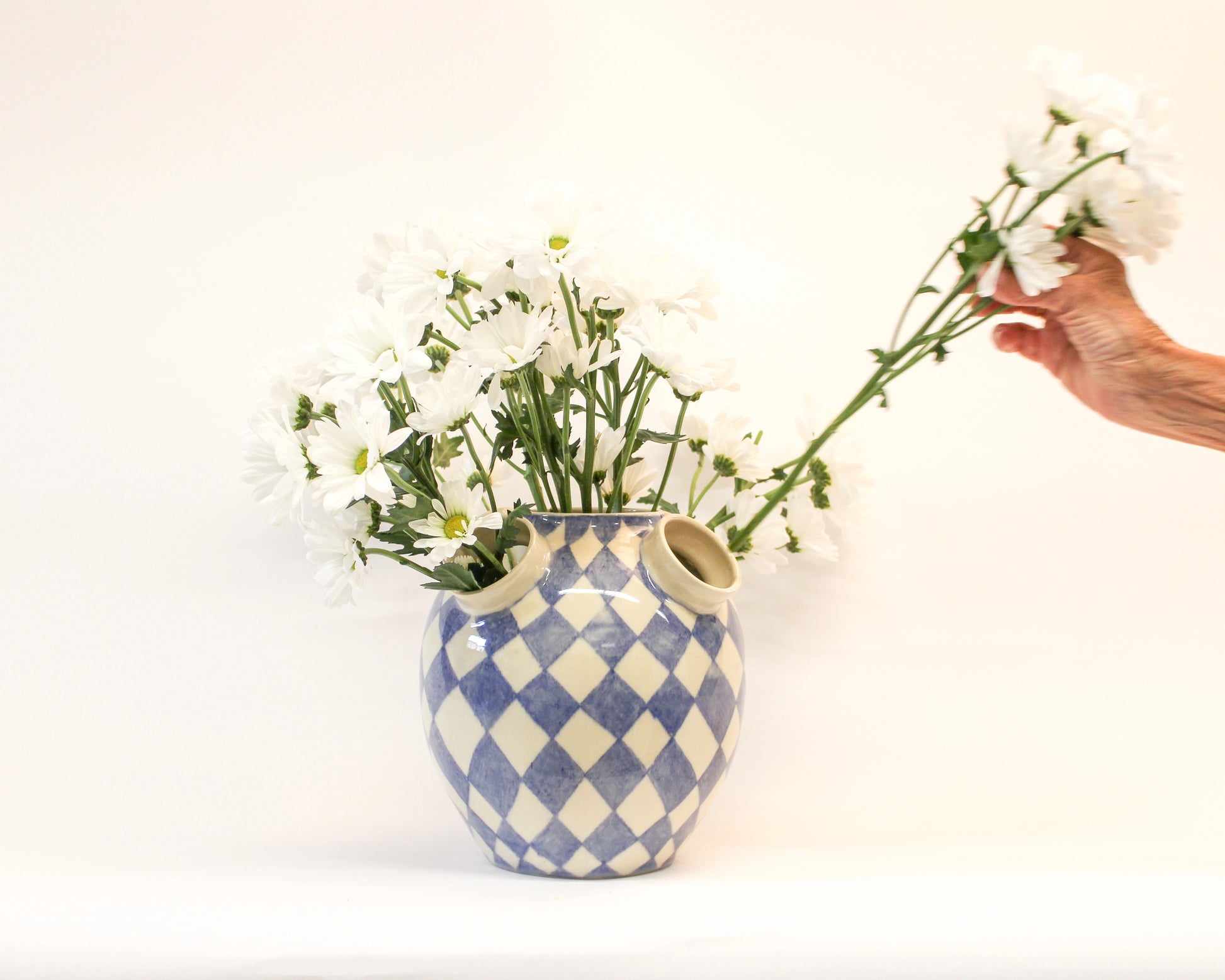 Handmade Ceramic Blue and white checkered vase with flowers on a white background from Mima Ceramics by Michelle Organ. 