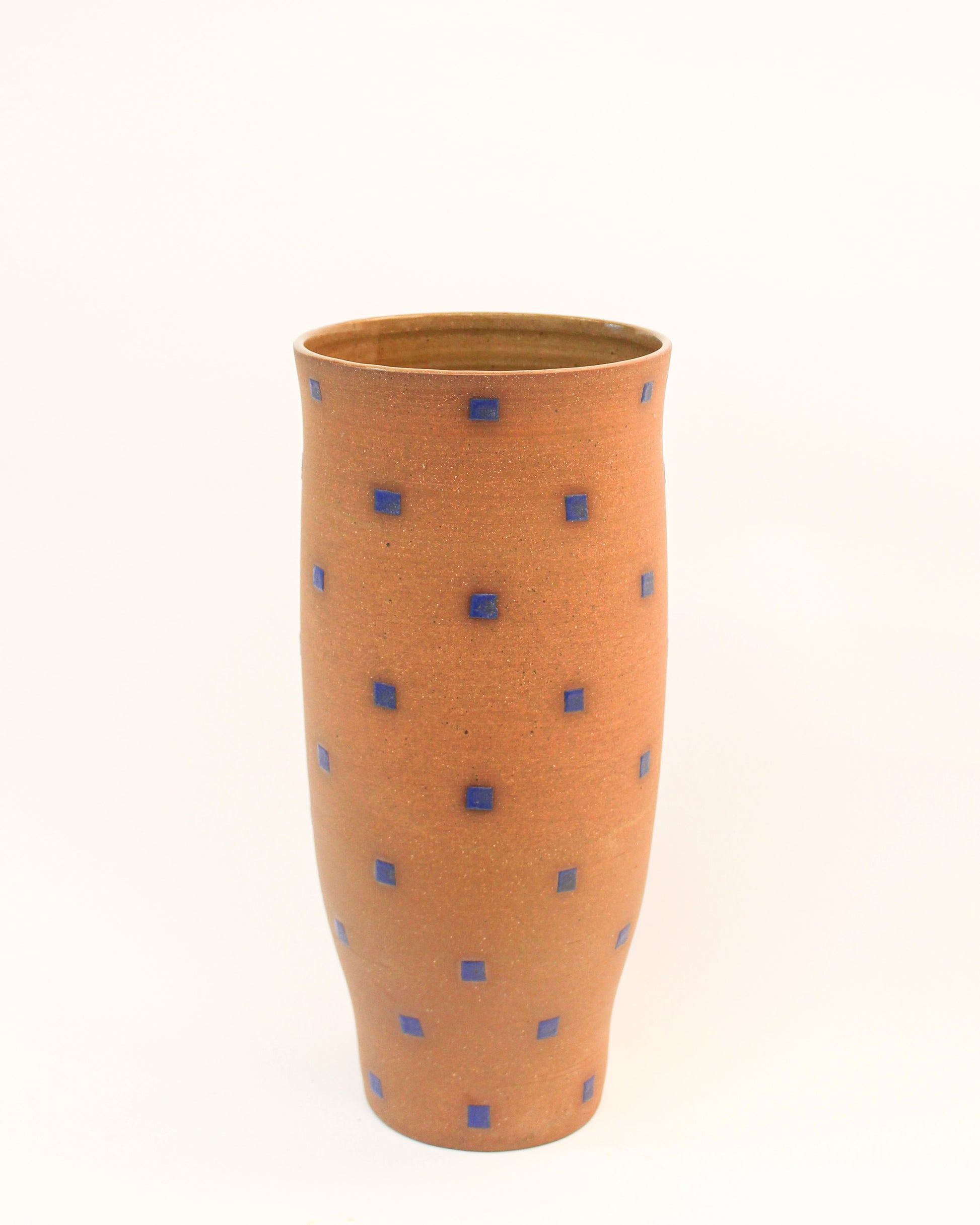 Handmade Cylindrical Red vase with blue square pattern on a white background from Mima Ceramics by Michelle Organ.