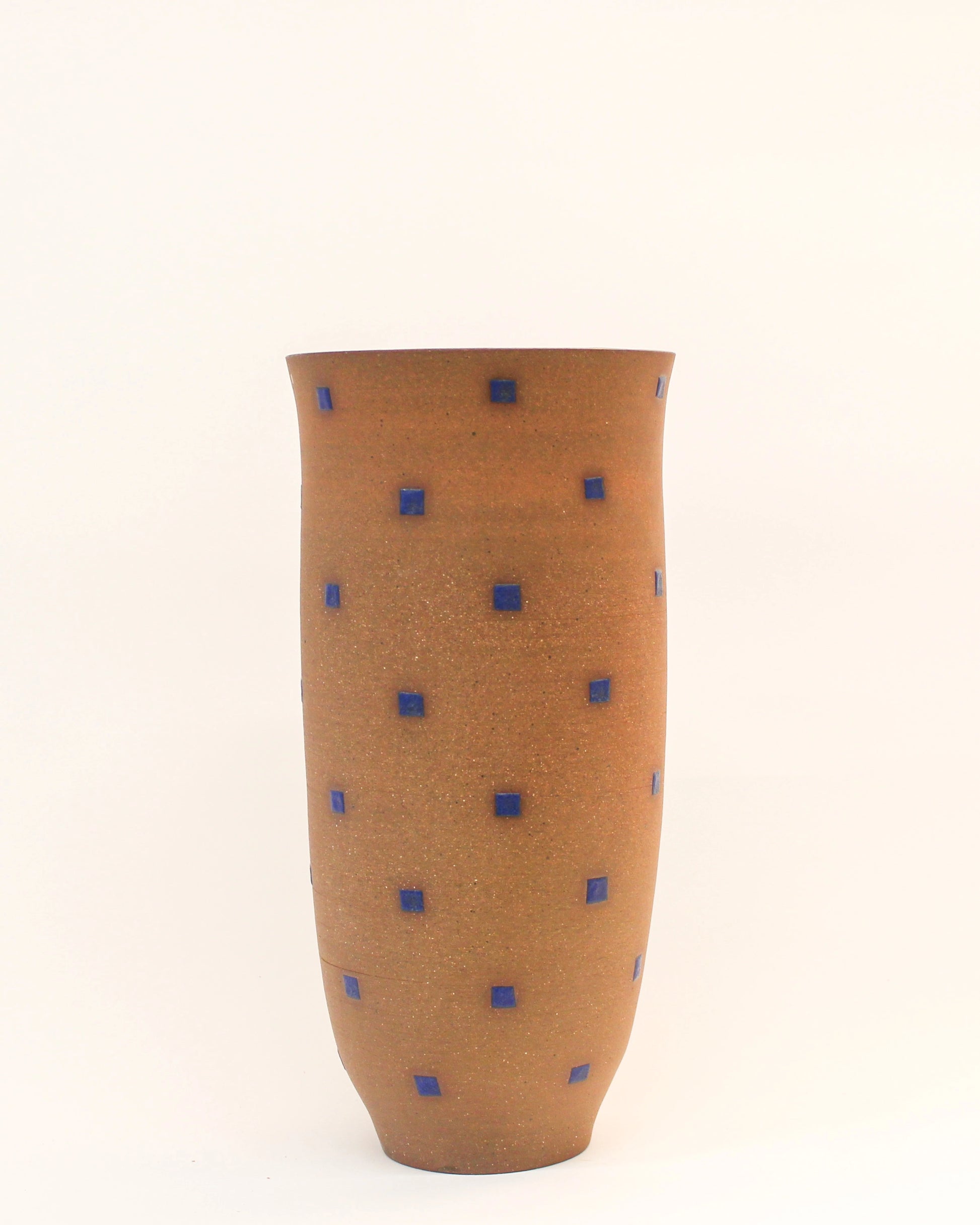 Handmade Cylindrical Red vase with blue dot pattern on a white background from Mima Ceramics by Michelle Organ. 