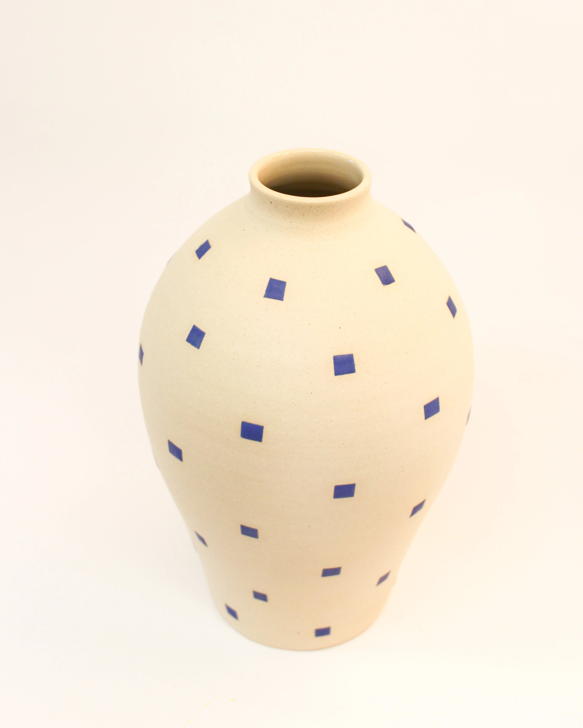 Handmade Cream vase with blue geometric patterns on a white background from Mima Ceramics by Michelle Organ. 