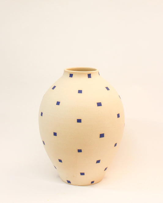 Handmade Round Cream-colored vase with blue polka dots on a light beige background from Mima Ceramics by Michelle Organ.